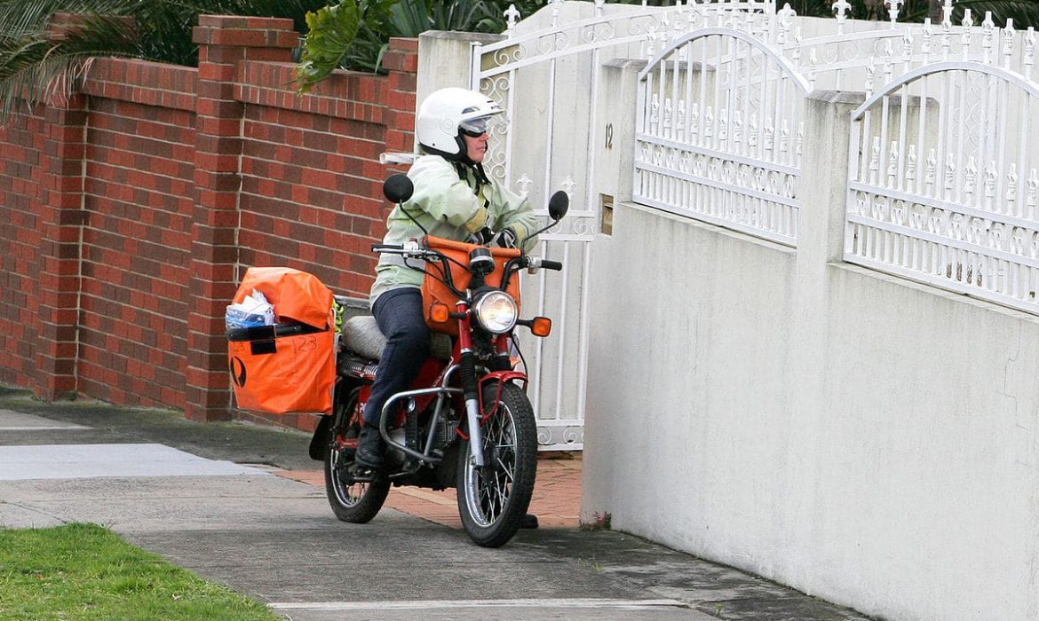 Tukang Post Menggunakan Sepeda Motor Untuk Mengantar Paket, Dokumen, Dan Surat